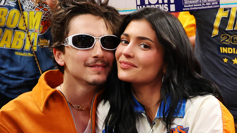 Timothée Chalamet and Kylie Jenner posing courtside