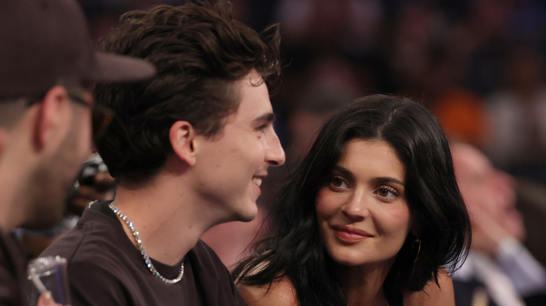 Timothee Chalamet and Kylie Jenner sitting courtside at basketball game