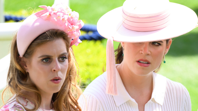 Princess Beatrice and Princess Eugenie whispering