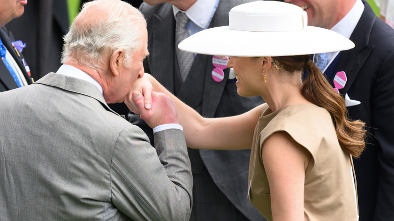 King Charles kisses Princess Eugenie on the hand
