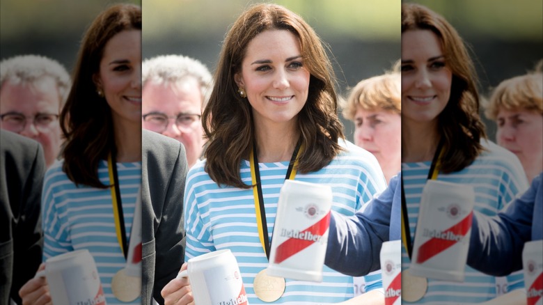 Kate Middleton smiling in a blue-and-white striped shirt.
