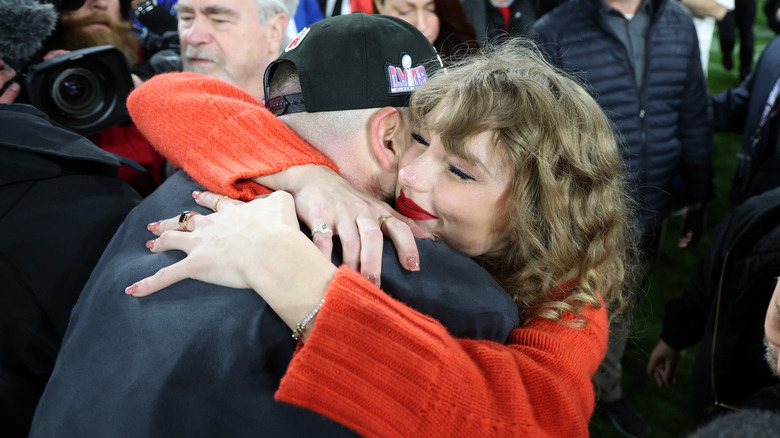 Taylor Swift hugging Travis Kelce after the Chiefs vs. the Baltimore Ravens game on January 28, 2024