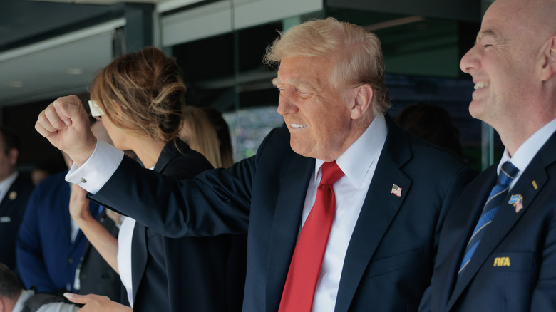 Donald Trump biting his lip and pumping a fist.