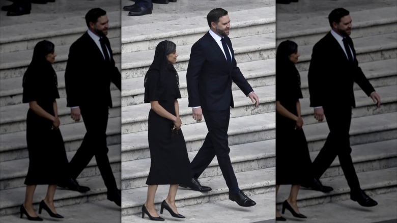 Usha and JD Vance walking down steps at the Vatican