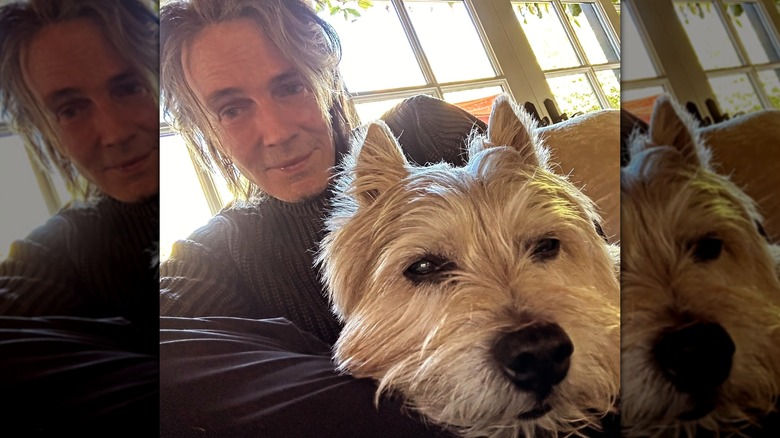 Rick Springfield resting with his dog at home
