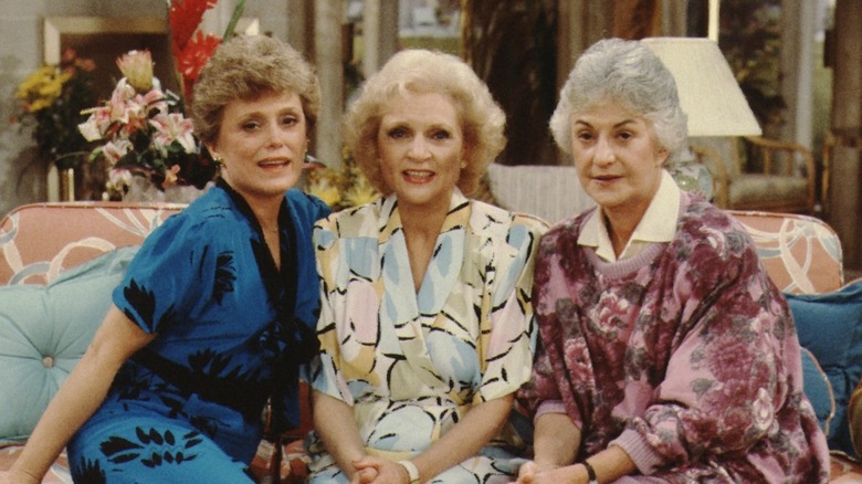 Rue McClanahan, Betty White, and Bea Arthur on the couch from The Golden Girls