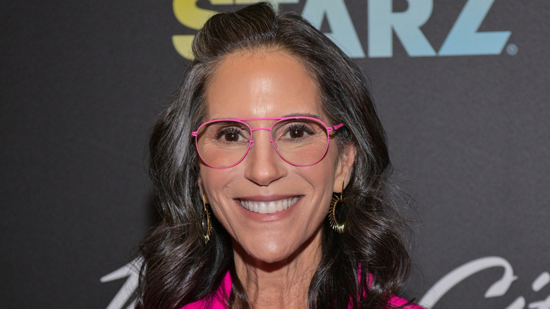 Jami Gertz at the "Magic City: An American Fantasy" premiere in Atlanta, Georgia in a hot pink suit and matching glasses frames
