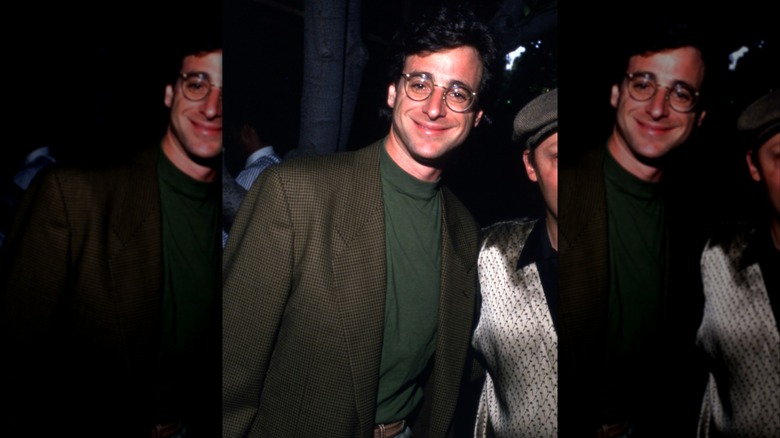 Bob Saget smiling at the camera in the 1980s