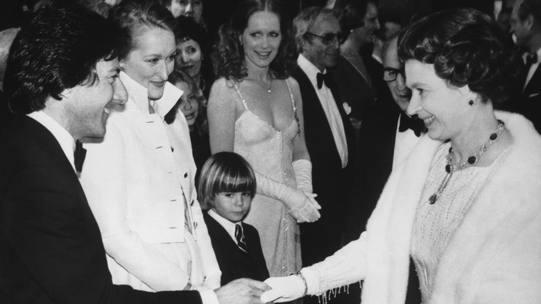 Dustin Hoffman shakes hands with Queen Elizabeth II at the Royal premiere of Kramer Versus Kramer, London, 1980.