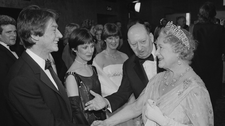 Queen Elizabeth meeting John Hurt and Jan Francis during the premiere of 'Champions' at Leicester Square, London, UK, 2nd March 1984.