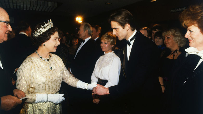 The Queen Shaking Hands with Jermey Irons at the 'EVIL UNDER THE SUN' FILM PREMIERE, LONDON, BRITAIN
