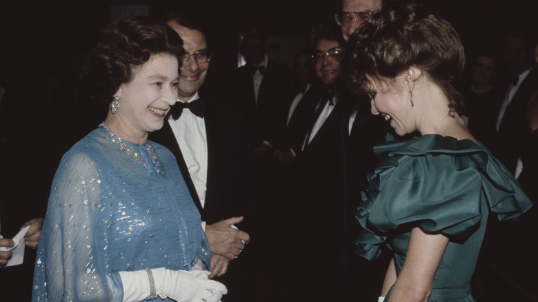 Queen Elizabeth II speaks with Sally Field meets at the premiere of 'Absence of Malice', held at the Odeon in Leicester Square, London, England, 24th February 1982.