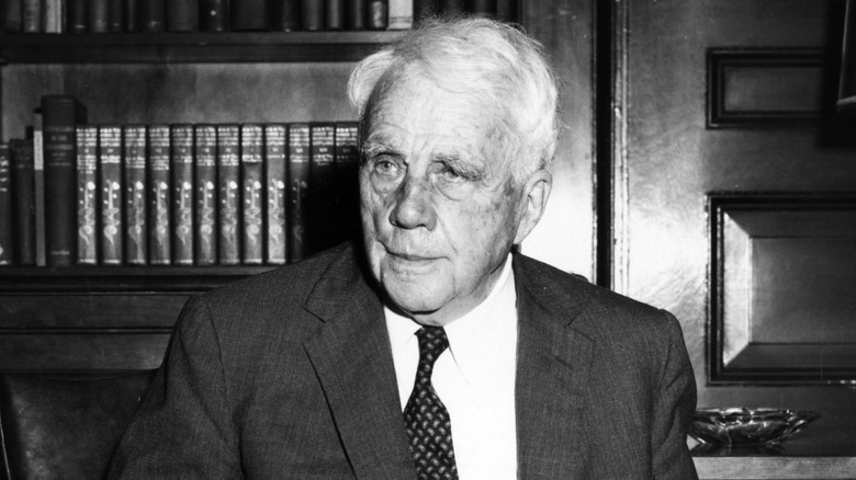 Robert Frost frowning in a suit
