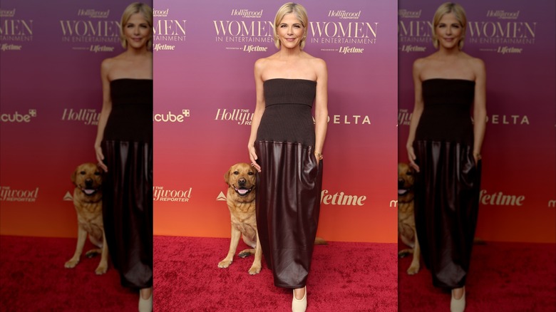 Selma Blair in burgundy strapless top and skirt with dog at the 2025 Women in Entertainment awards