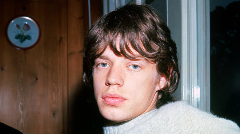 Mick Jagger closeup non smiling wearing gray sweater