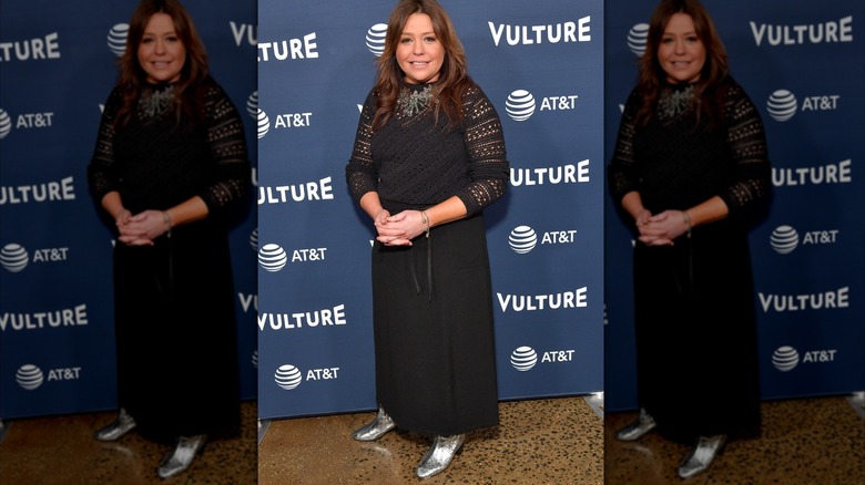 Rachael Ray wearing an outdated black knitted dress and silver ankle boots