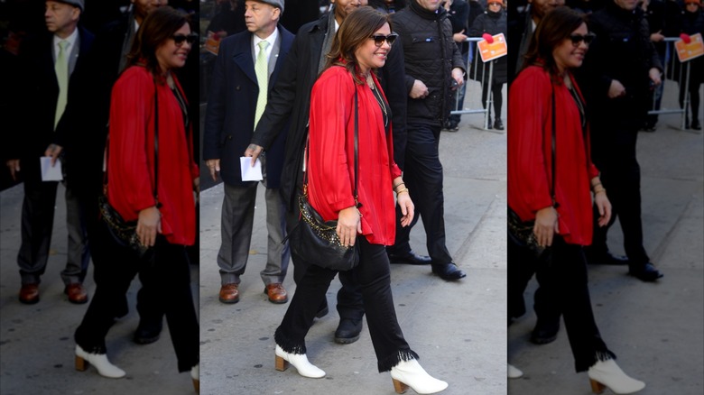 Rachael Ray wearing an outdated pair of black fringe hem jeans and white booties