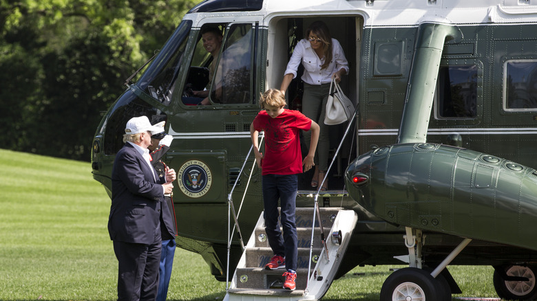 Melania Trump follows Barron Trump down the steps of Marine One.