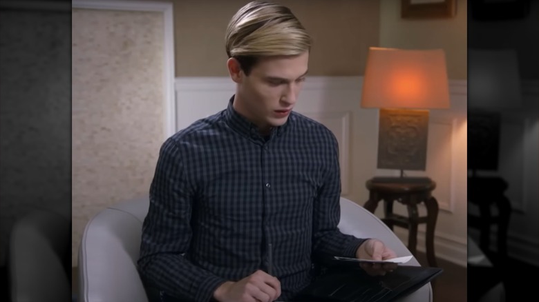 Tyler Henry holding photographs during session