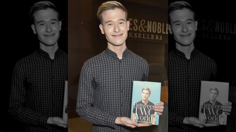 Tyler Henry holding his book at Barnes & Noble in 2017