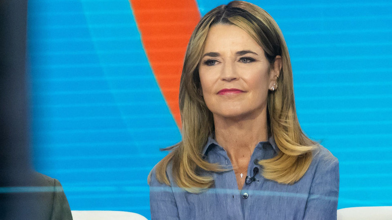 Savannah Guthrie looking serious while wearing a blue linen shirt