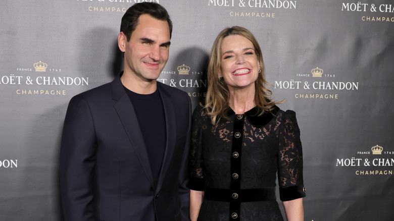 Savannah Guthrie grinning next to Roger Federer