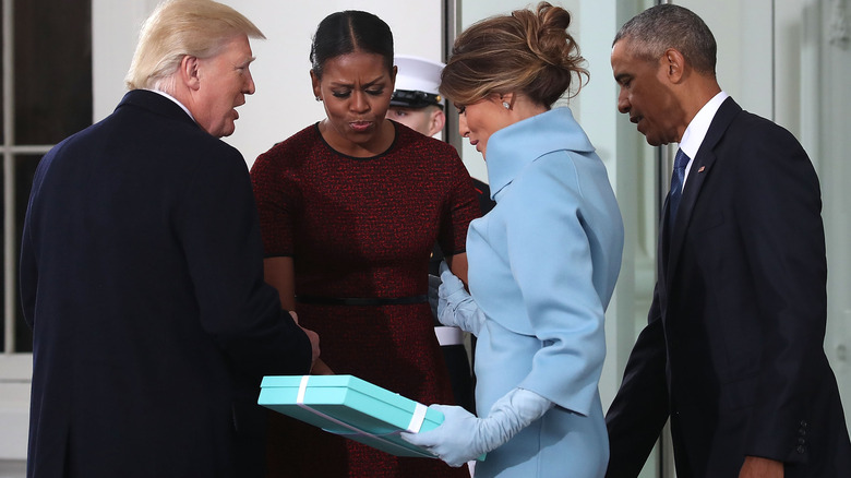 Michelle Obama receiving a gift from Melania Trump