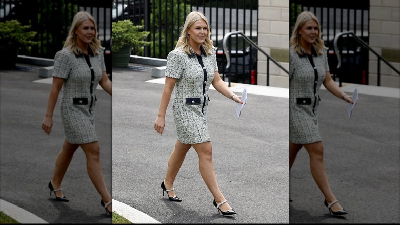 Karoline Leavitt walking in a black and white bouclé dress