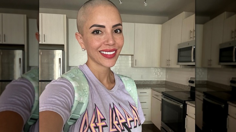 Jasmine Pineda smiling while showing off her shaved head.
