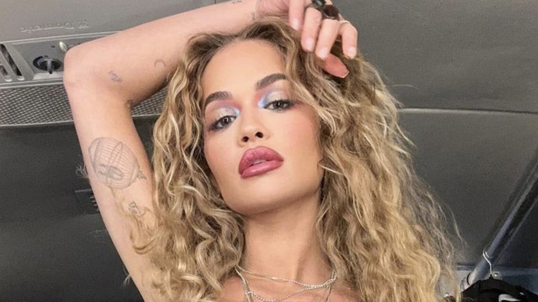 Rita Ora with blonde bouncy curls