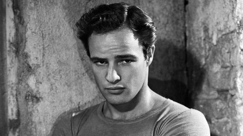 A black-and-white photo of Marlon Brando with a serious facial expression