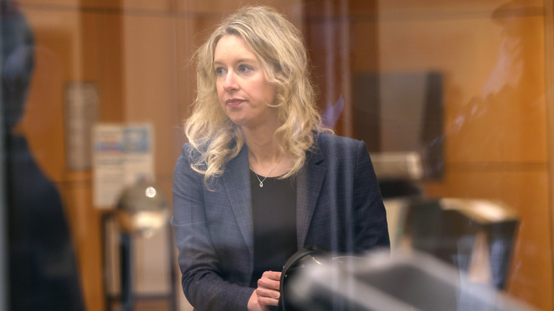 Elizabeth Holmes arrives at security in court