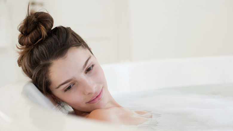 woman soaking in bathtub