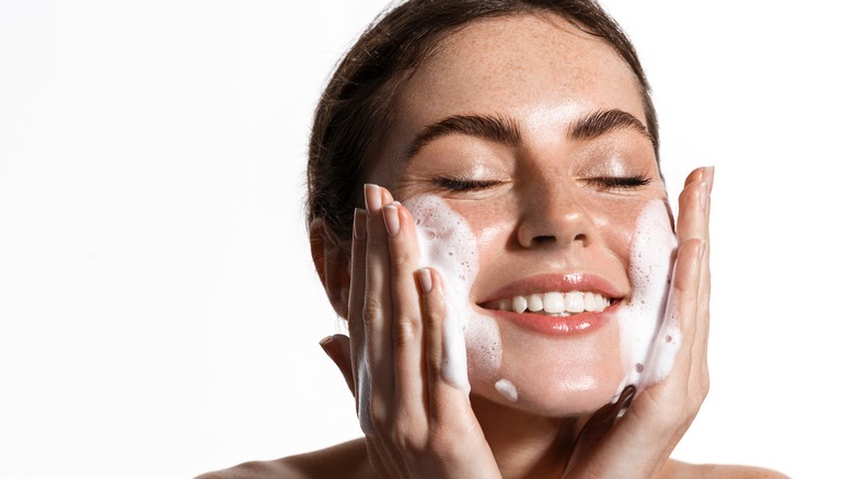 woman washing her face