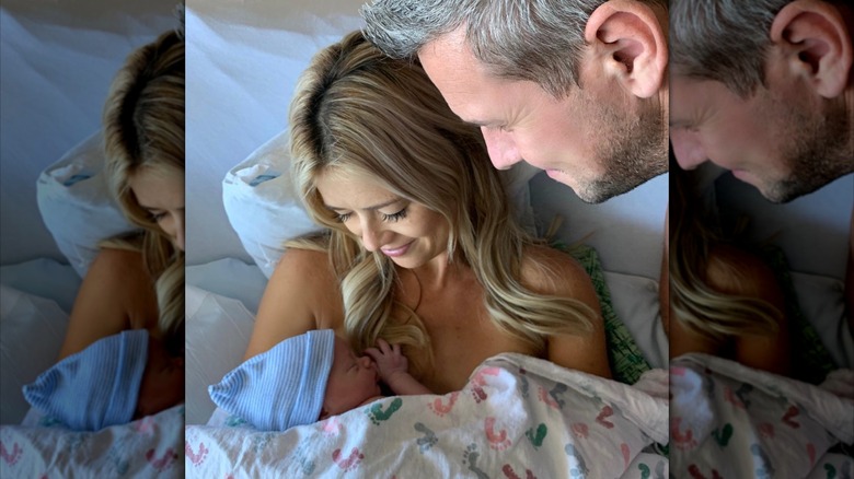 Christina Haack holding her newborn baby while Ant Anstead stands over them