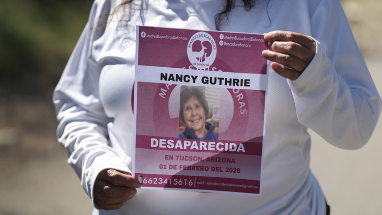 A woman holding a missing persons sign