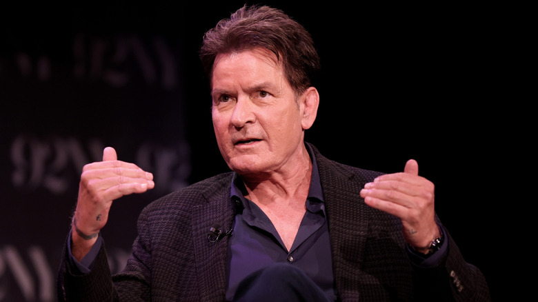 Charlie Sheen talking and gesturing with his hands