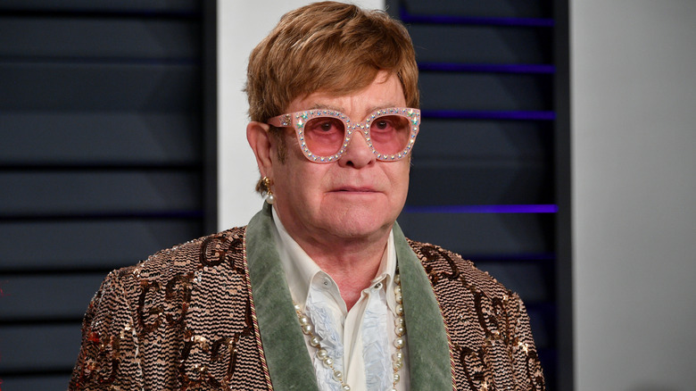 Elton John wearing colored glasses