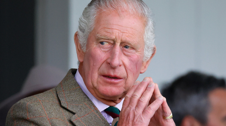 King Charles III with hands touching