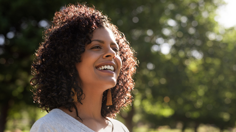 Woman with curly hair enjoying the sunshine