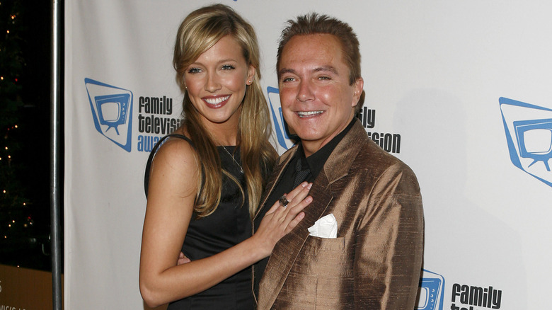 Katie Cassidy posing with dad David at event