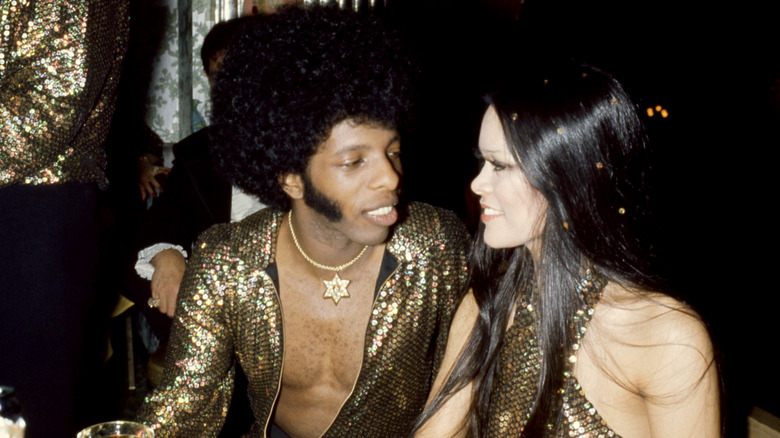 Sly Stone and Kathy Silva at their wedding reception party wearing gold sequined outfits