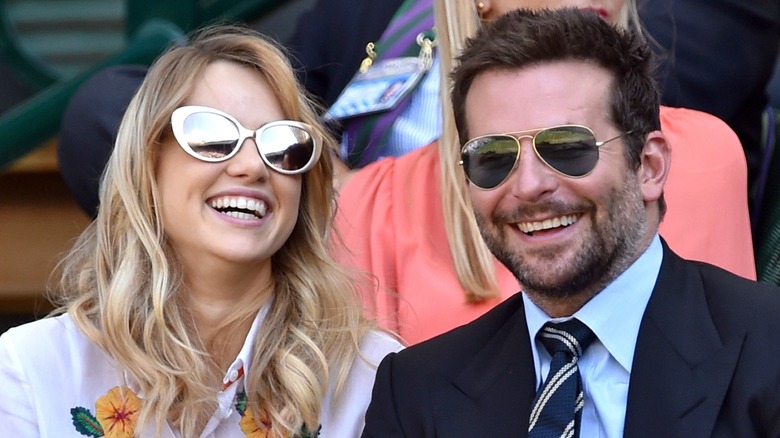 Suki Waterhouse Bradley Cooper smiling in sunglasses
