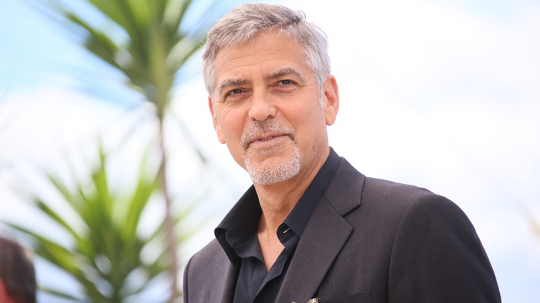 White-haired George Clooney in the sun