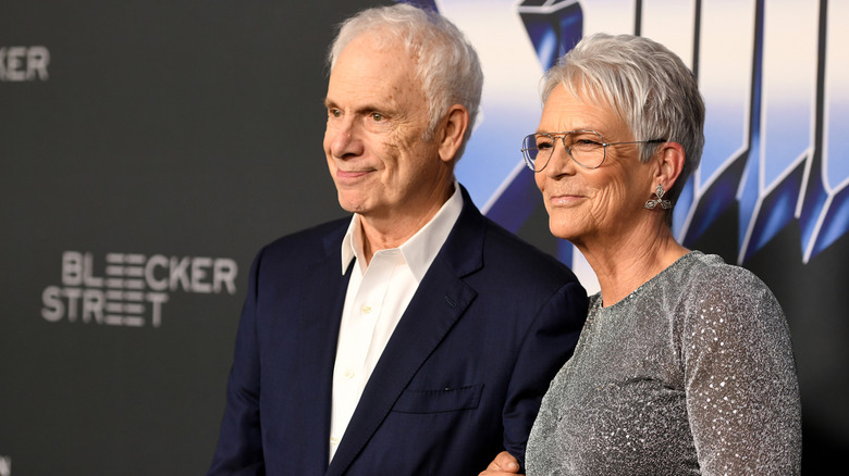 Jamie Lee Curtis and husband Christopher Guest smiling and posing.