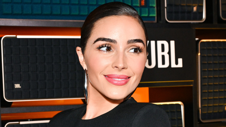 Olivia Culpo smirks on the red carpet