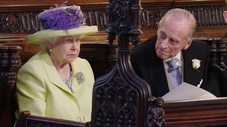 Queen Elizabeth II and Prince Philip staring