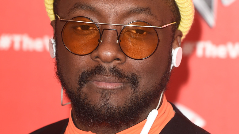 Will.i.am smiles at camera