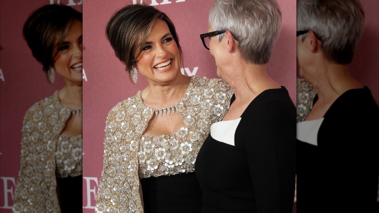 Mariska Hargitay smiling at Jamie Lee Curtis while wearing her black and white floral gown