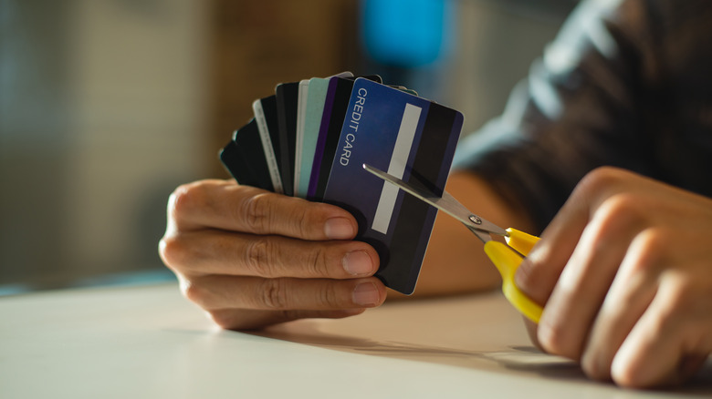 A man cutting his credit cards